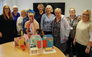 Charity CEO Dr Hannah Moody - left - and fundraiser Rachel Hunter - right - with their guests flanking Tommy Torso